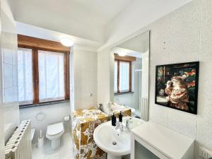 a white bathroom with a sink and a toilet at La casa di AngeLis in Stezzano +25 photos