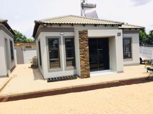 a small house with a roof on a patio at Miaz Palace in Elim