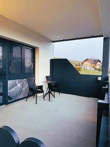 a room with chairs and a table and a large window at Kickmaier's in Kirchbach in Steiermark