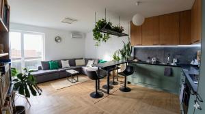 a kitchen and living room with a table and a couch at Apartament Rutkiewicz in Łańcut