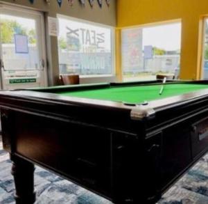 a pool table in a room with a green table at Ailsa Seaview in Turnberry