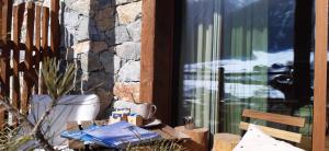 a window of a building with a table and a chair at Green Hospitality Monolocale Stella Alpina in Livigno