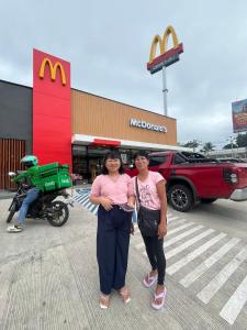 two women standing in front of a mcdonalds store at Hailey's Place Unit 3 in Bacolod