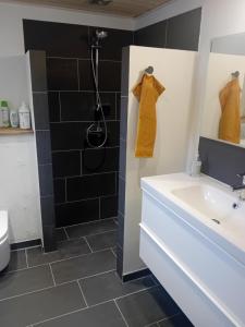 a bathroom with a sink and a shower at "City Sleep" in Nykøbing Mors +8 photos