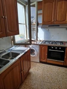 a kitchen with a sink and a stove and a dishwasher at Casa Milda in Capoliveri