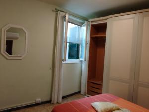 a bedroom with a window and a bed and a mirror at Casa Milda in Capoliveri