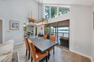 a kitchen and dining room with a table and chairs at Sundance - Lakefront w/ Private Dock in Moneta