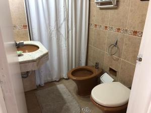 a bathroom with a toilet and a sink at Celestia in Punta del Este +9 photos