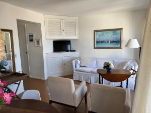 a living room with a white couch and a table at Celestia in Punta del Este