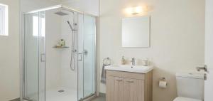 a bathroom with a glass shower and a sink at Levent Hotel in Lara