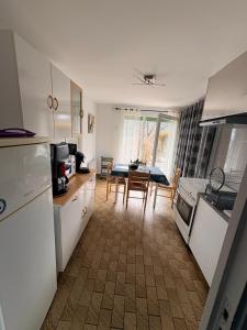 a kitchen with a table and a dining room at Abéane in Châtel-Guyon