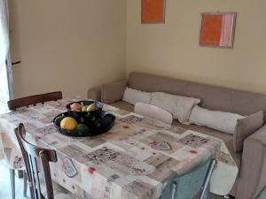 a table with a bowl of fruit on it in a living room at Siciliana in Caronia +38 photos