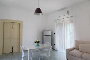 a white living room with a table and a couch at Gragnano in in Gragnano