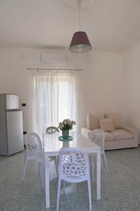 a white table and chairs in a living room at Gragnano in in Gragnano +9 photos