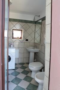 a bathroom with a toilet and a sink and a mirror at Gragnano in in Gragnano