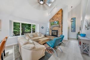 a living room with a couch and a fireplace at Sundance - Lakefront w/ Private Dock in Moneta