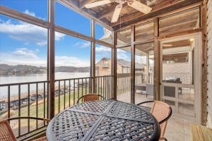 a table and chairs on a balcony with a view of the water at Lake Vibes - Pet Friendly Lakefront Condo! in Moneta
