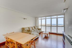 a living room with a couch and a table at Orio Playa in Orio