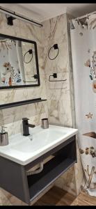 a bathroom with a white sink and a mirror at Aegean escape in Mytilini in Mytilene