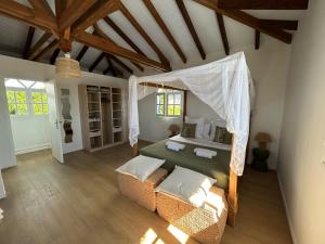 a bedroom with a bed with a canopy at Domaine Madinina Dream in Sainte-Luce +29 photos