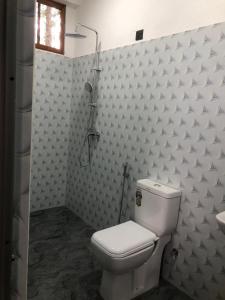 a bathroom with a toilet and a shower at Ella 96TN Resort in Ella