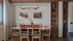 a dining room with a table and chairs at Silva: The Alpine Chalet in Livigno