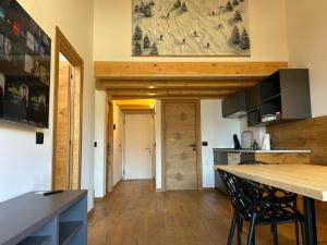 a kitchen with a counter and a wooden ceiling at Dolomiti Panorama - 3 Rooms in Carano