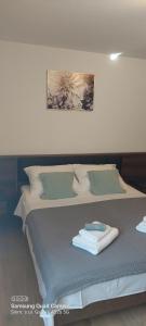 a bed with a towel on top of it at Room Depikolo 2 in Krk