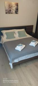 a bed with two towels on top of it at Room Depikolo 2 in Krk