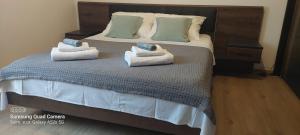 a bedroom with a bed with towels on it at Room Depikolo 2 in Krk