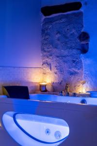 a bathroom with a white sink in a room at La Sensuelle Suite with spa in Vendres