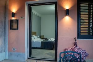 a doorway to a room with a bed and a mirror at B&B Med - Finestra sul Mare in Contrada Mastrissa