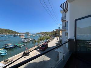a balcony with a view of a harbor with boats at Hotel Vũng Găng in Vĩnh Hy