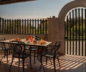 a table and chairs with food on a patio at B&B Med - Finestra sul Mare in Contrada Mastrissa +13 photos