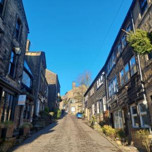 an empty cobblestone street in an old town at Harrys Hideaway Cottage in Haworth