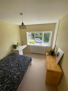 a bedroom with a bed and a table and a window at Peaceful Fields in Lancaster +4 photos