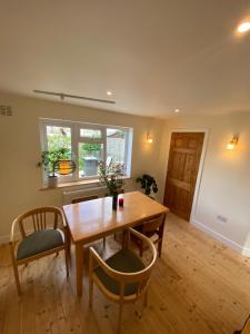 a dining room with a wooden table and chairs at Peaceful Fields in Lancaster