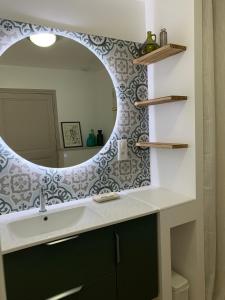a bathroom with a sink and a mirror at Domaine de Grave in Mirepoix +41 photos