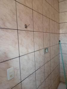 a tiled shower with a hose in a bathroom at Hotel Ouro Fino in Uruaçu +37 photos