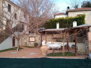 a house with a patio in front of a building at Evelin Apartment in Portaria