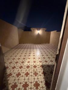 a room with a tiled floor with a light on it at Dar Al-Areed in Medina