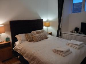 a bedroom with a bed with towels on it at Teach Sile in Kiltimagh