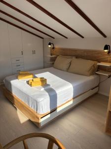 a bedroom with a large bed with a wooden headboard at Centraal Blue in Iraklitsa