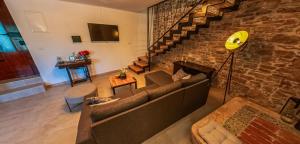 a living room with a couch and a brick wall at Casa Pasqua in Barban