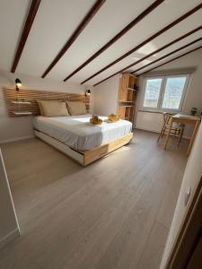 a bedroom with a large bed and a table at Centraal Blue in Iraklitsa