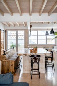 a kitchen with a large island in a room with windows at Cornise in El Rompido +9 photos