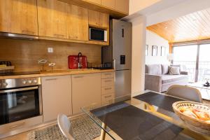 a kitchen with a glass table in a room at Atticview Oropos in Néa Palátia