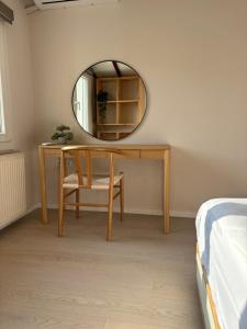 a dressing table with a mirror and a chair at Centraal Blue in Iraklitsa +40 photos