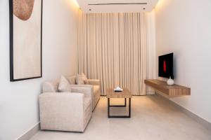 a living room with a couch and a table at فندق ارجان بارك طويق 2 in Riyadh