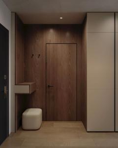 a bathroom with a wooden door and a toilet at Apart-hotel Centr in Sumy +2 photos